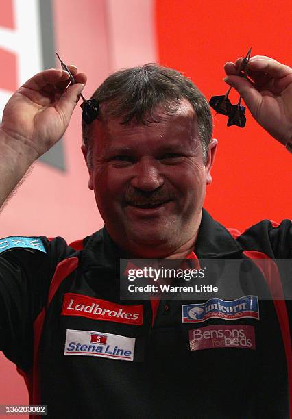 Terry Jenkins of England celebrates after beating Justin Pipe of England during Day 11 of the 2012 Ladbrokes.com World Darts Championship at...