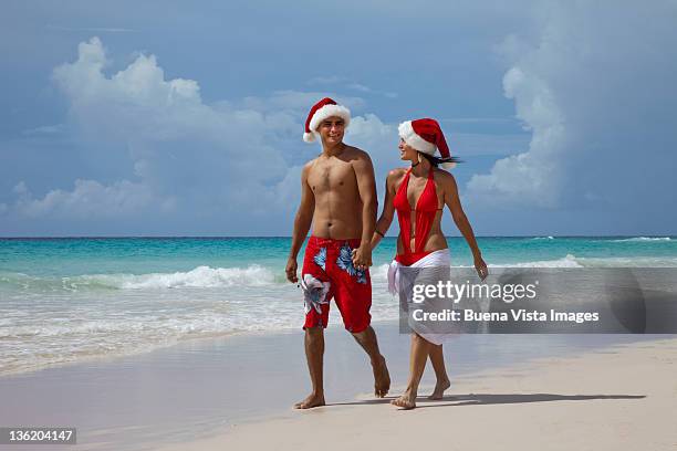 couple with santa hat  on a tropical beach - bridgetown barbados stock pictures, royalty-free photos & images