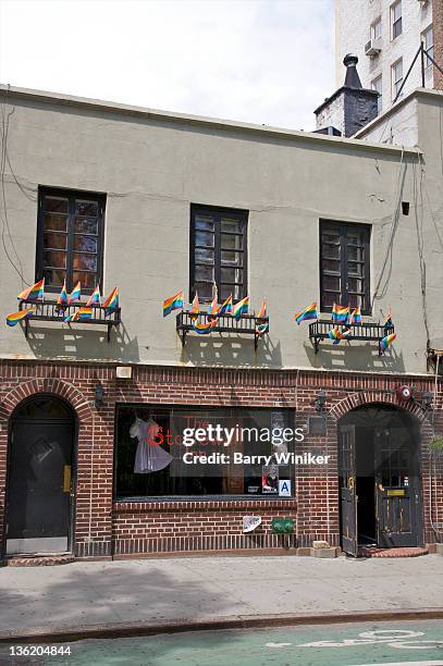 flags above window with neon sign. - stonewall inn stock pictures, royalty-free photos & images