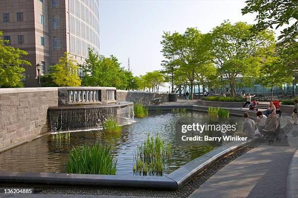 family at pool and fountain in city park. - battery park stock pictures, royalty-free photos & images