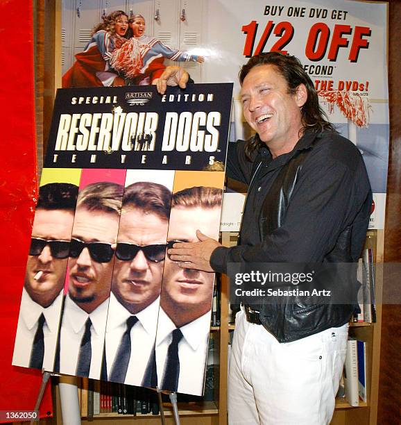 Actor Michael Madsen poses next to a "Reservoir Dogs" poster on August 30, 2002 in Los Angeles, California.