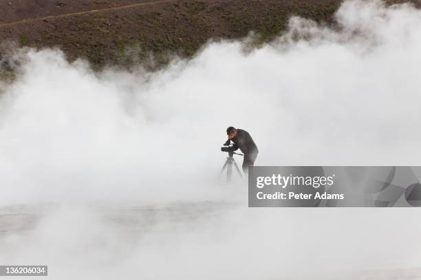 videographer filming at geothermal pools, iceland - film crew outside stock pictures, royalty-free photos & images