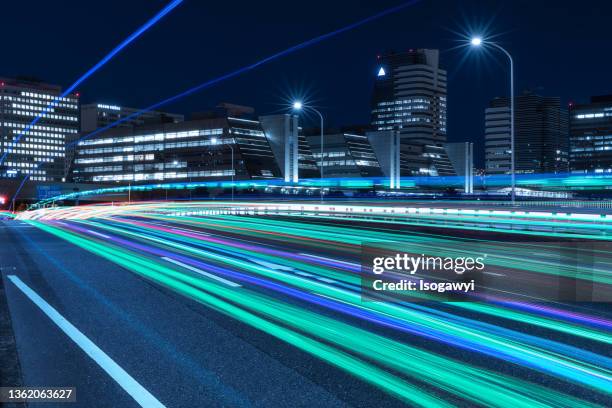 light trails at tokyo waterfront business district - construction lighting equipment stock pictures, royalty-free photos & images