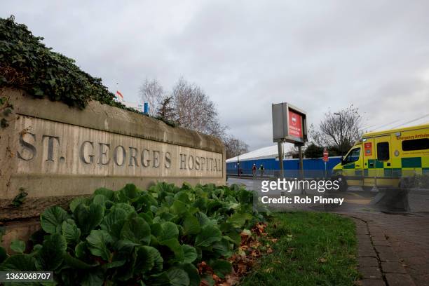 An ambulance drives past a Nightingale Surge Hub under construction in the grounds of St George's Hospital on December 31, 2021 in London, England....