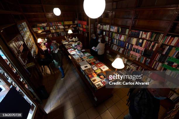 People consult books in the Pergamo bookstore on December 31, 2021 in Madrid, Spain. The Libreria Pergamo will close its doors after 76 years of...