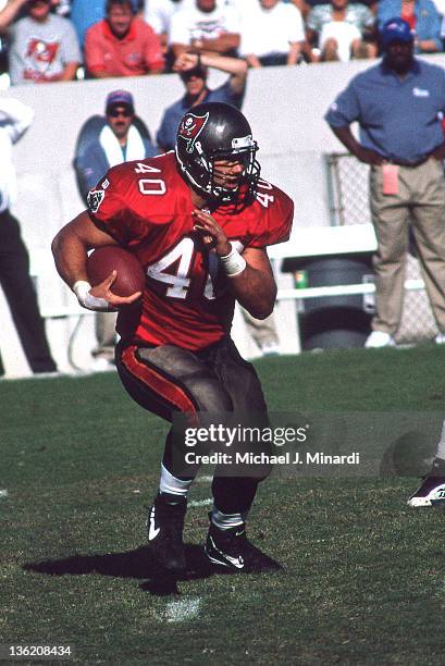 Full Back Mike Alstott of the Tampa Bay Buccaneers makes some extra yardage in a NFL game against the New England Patriots at Tampa Stadium on...