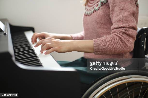 disabled woman playing a piano - pianist stock pictures, royalty-free photos & images