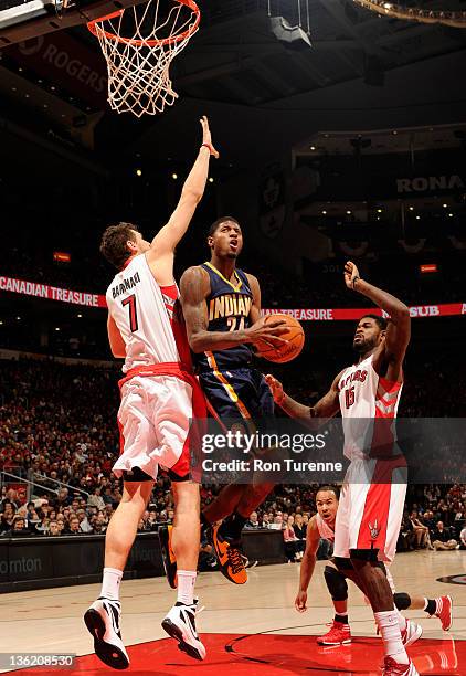 Paul George of the Indiana Pacers shoots the basketball against Andrea Bargnani of the Toronto Raptors during the game on December 28, 2011 at the...