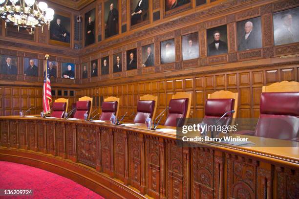 portraiture above carved wood desk in courtroom. - empty courtroom stock-fotos und bilder