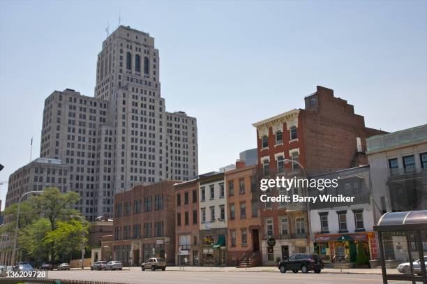 small buildings and huge office tower. - small office building exterior stock pictures, royalty-free photos & images