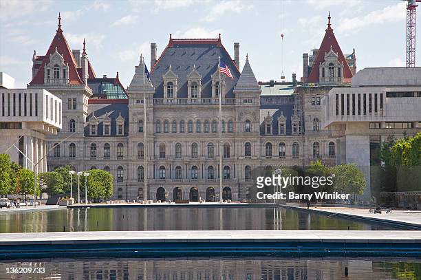 gothic-style building behind reflecting pools - albany new york stock pictures, royalty-free photos & images