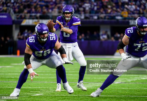 Kirk Cousins of the Minnesota Vikings takes the snap in the second quarter of the game against the Los Angeles Rams at U.S. Bank Stadium on December...