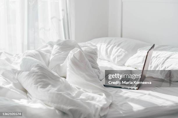 laptop in the bed. - bed sun stock pictures, royalty-free photos & images