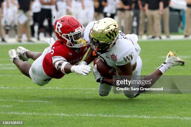Donald Stewart of the Wake Forest Demon Deacons makes a reception against Kessawn Abraham of the Rutgers Scarlet Knights during the TaxSlayer Gator...