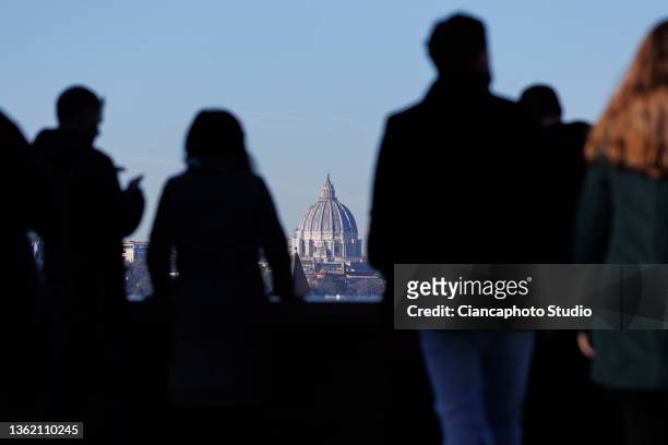 Tourists observe St. Peter's Dome from the "Belvedere Luigi Magni" terrace on December 31, 2021 in Rome, Italy.