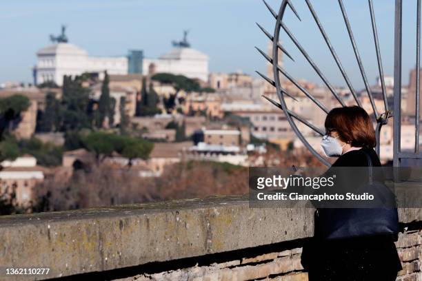 Woman observes the panorama with the Altare della Patria from the "Belvedere Luigi Magni" terrace near the historic center of Rome on December 31,...