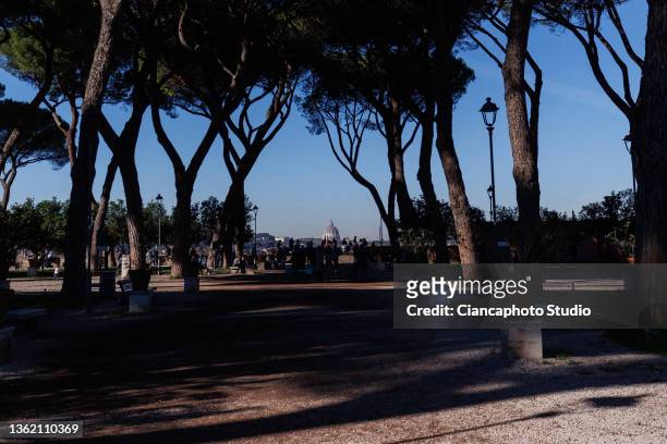 Tourists observe St. Peter's Dome from the "Belvedere Luigi Magni" terrace near the historic center of Rome on December 31, 2021 in Rome, Italy.
