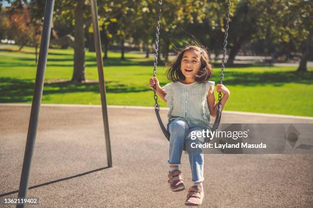 5 year old girl on playground swing - 5 year stock pictures, royalty-free photos & images