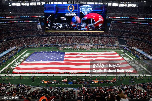 The American Flag is shown across the field during the national anthem prior to the Goodyear Cotton Bowl Classic for the College Football Playoff...