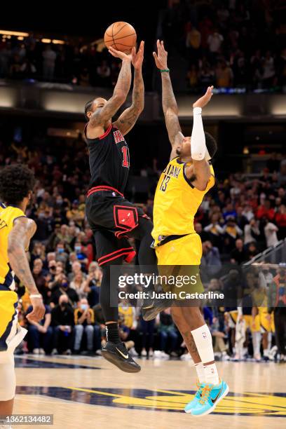 DeMar DeRozan of the Chicago Bulls shoots the game winning 3-pointer as time expires while guarded by Torrey Craig of the Indiana Pacers at...