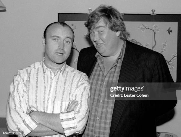 English drummer, singer, record producer, songwriter, and actor Phil Collins and Canadian actor and comedian John Candy , pose for a portrait circa...