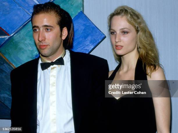 American actor and filmmaker Nicolas Cage and American actress Bridget Fonda attend an event circa 1989 in Los Angeles, California.