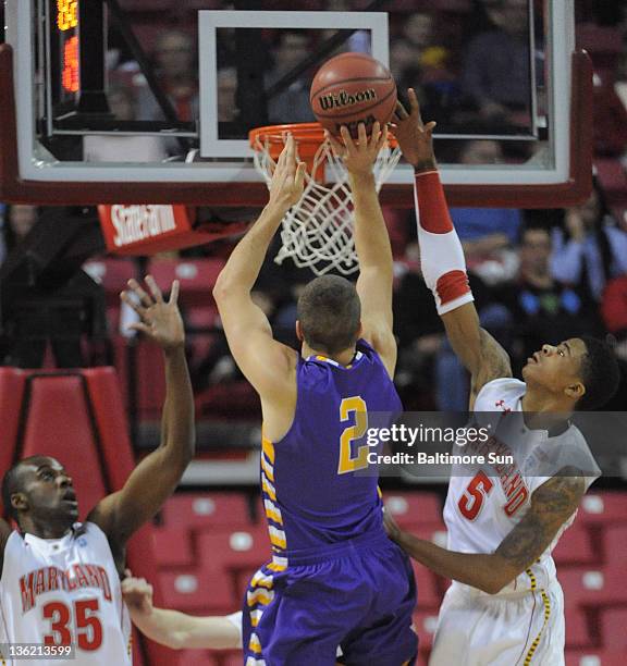 Maryland's Nick Faust rejects this shot by Albany's Logan Aronhalt during first-half action in College Park, Maryland, Wednesday, December 28,2 2011.