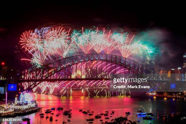Fireworks light up the sky over the Sydney Harbour Bridge during New Year's Eve celebrations on January 01, 2022 in Sydney, Australia. New Year's Eve...