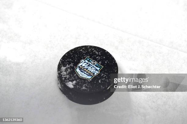 Detailed view of an official Winter Classic puck prior to the Minnesota Wild team practice session before the 2022 NHL Winter Classic between the St....