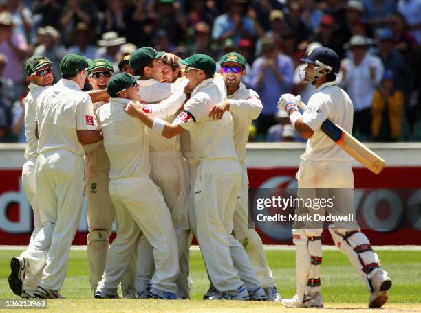 Ben Hilfenhaus of Australia celebrates with teammates after the wicket of Virat Kohli of India during day four of the First Test match between...