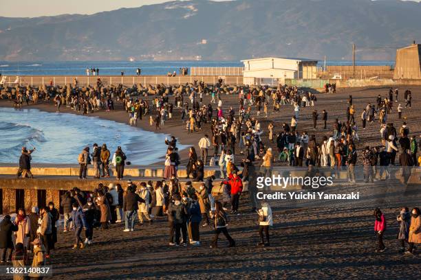 People visit Southern Beach Chigasaki to watch the sunrise on January 01, 2022 in Chigasaki, Japan. As Covid-19 coronavirus infections remain low...