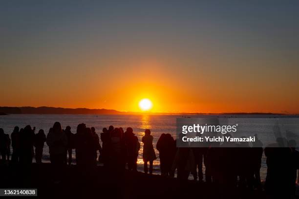 People watch the sunrise at Southern Beach Chigasaki on January 01, 2022 in Chigasaki, Japan. As Covid-19 coronavirus infections remain low across...