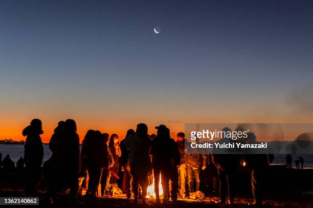 People make bonfire to warm them as they wait for the sunrise at Southern Beach Chigasaki on January 01, 2022 in Chigasaki, Japan. As Covid-19...