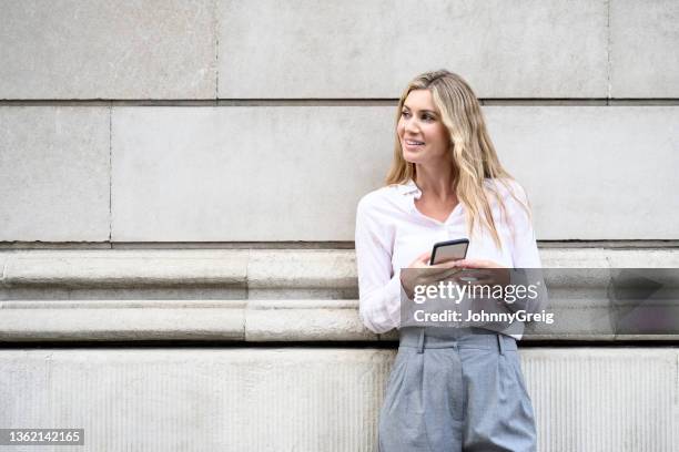 early 30s caucasian businesswoman outdoors with smart phone - colarinho aberto imagens e fotografias de stock