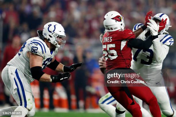 Guard Chris Reed and offensive tackle Julie'n Davenport of the Indianapolis Colts block outside linebacker Chandler Jones of the Arizona Cardinals...