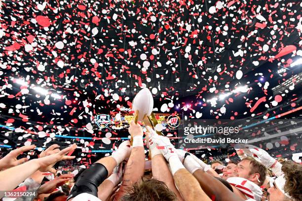 The Wisconsin Badgers celebrate with the championship trophy after defeating the Arizona State Sun Devils 20-13 to win the SRS Distribution Las Vegas...