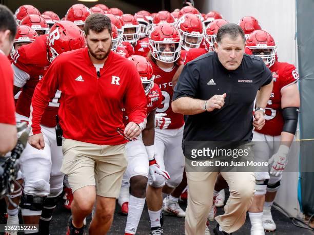 Head Coach Greg Schiano of the Rutgers Scarlet Knights runs on field before the start of the game against the Wake Forest Demon Deacons at the 77th...