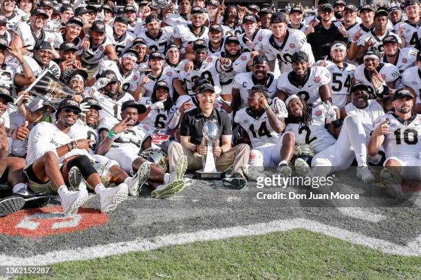 Head Coach Dave Clawson of the Wake Forest Demon Deacons pose with his entire team on the field after the game against the Rutgers Scarlet Knights at...