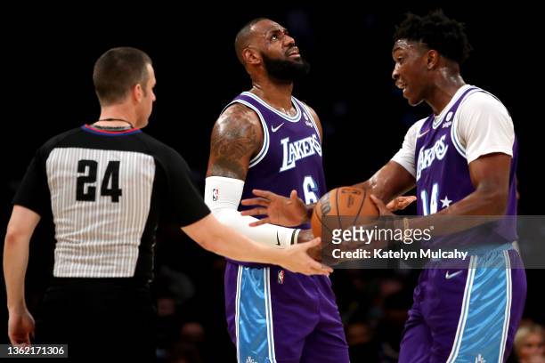 Stanley Johnson and LeBron James of the Los Angeles Lakers react to a foul called with referee Kevin Scott during the third quarter against the...