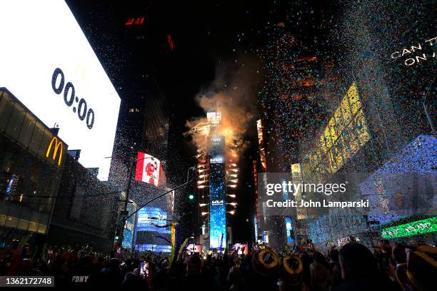 Confetti fall as the ball drops over Times Square during the 2022 New Year’s Eve celebrations on January 01, 2022 in New York City. Despite a major...