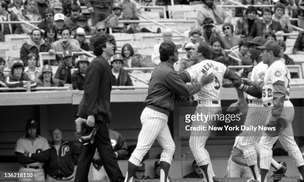Mets' manager Joe Torre , Willie Montanez and coach Joe Pignatano restrain Richie Hebner after he was heaved in the first inning of opener against...