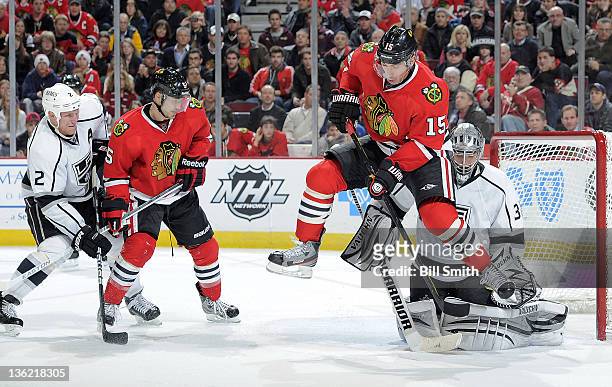 Andrew Brunette of the Chicago Blackhawks jumps in front of Los Angeles Kings goalie Jonathan Quick to avoid the puck, as Steve Montador of the...