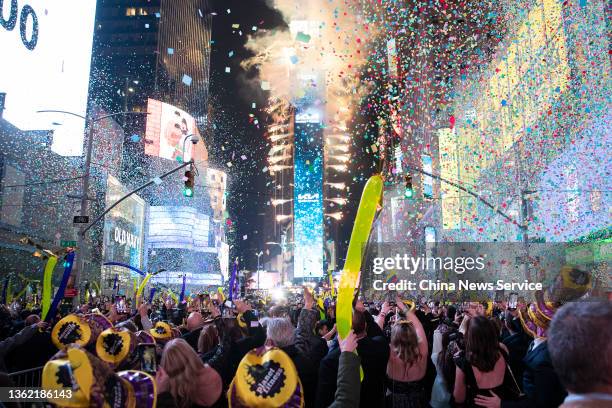 Confetti flies in the air as revelers celebrate during the Times Square New Year's Eve 2022 Celebration on January 1, 2022 in New York City.