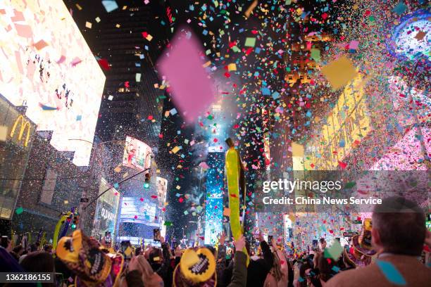 Confetti flies in the air as revelers celebrate during the Times Square New Year's Eve 2022 Celebration on January 1, 2022 in New York City.