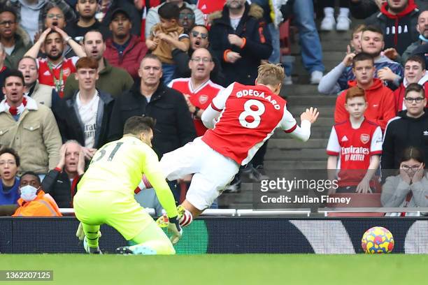 Martin Odegaard of Arsenal is challenged inside the box by Ederson of Manchester City during the Premier League match between Arsenal and Manchester...