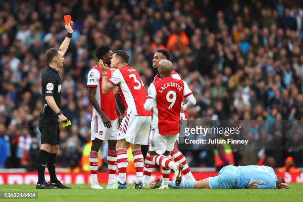 Gabriel Magalhaes of Arsenal is shown a second yellow card leading to a red card by Referee, Stuart Attwell for a foul on Gabriel Jesus of Manchester...