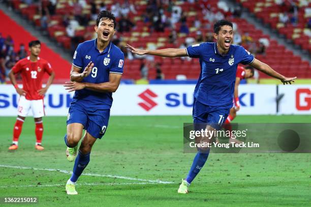 Adisak Kraisorn of Thailand celebrates with Bordin Phala after scoring their first goal against Indonesia in the second half during the second leg of...