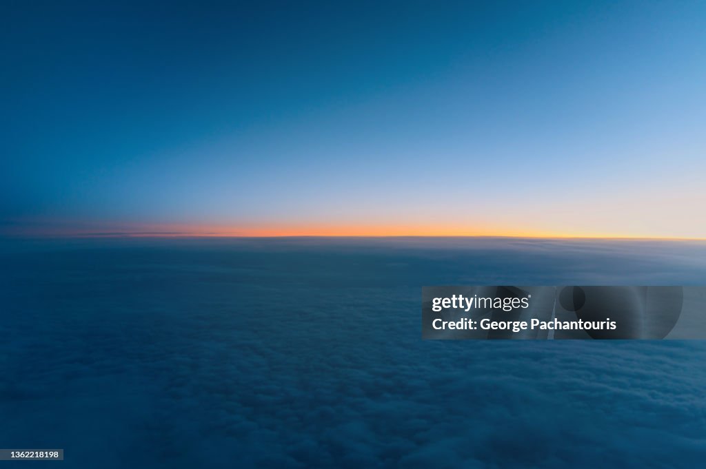 Aerial photo of  sunrise above the clouds from while in flight