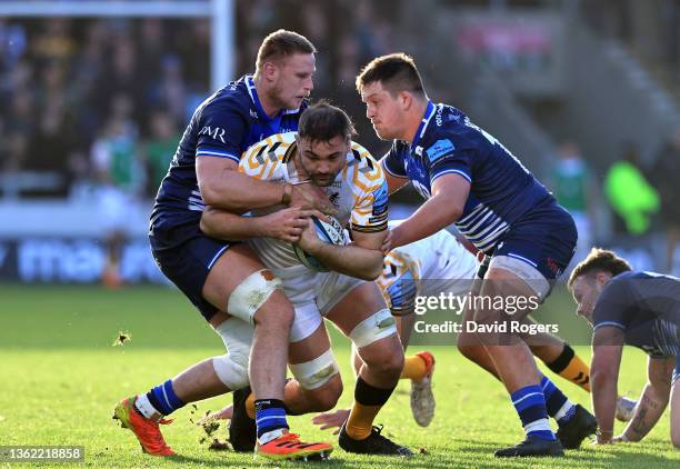 Elliott Stooke of Wasps is held by Jean-Luc du Preez and Nick Schonert during the Gallagher Premiership Rugby match between Sale Sharks and Wasps at...