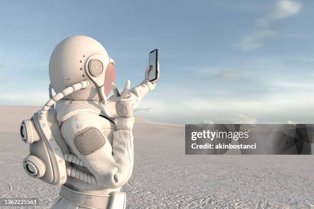 astronaut exploring new planet and takes a selfie - remote location cell phone stock pictures, royalty-free photos & images